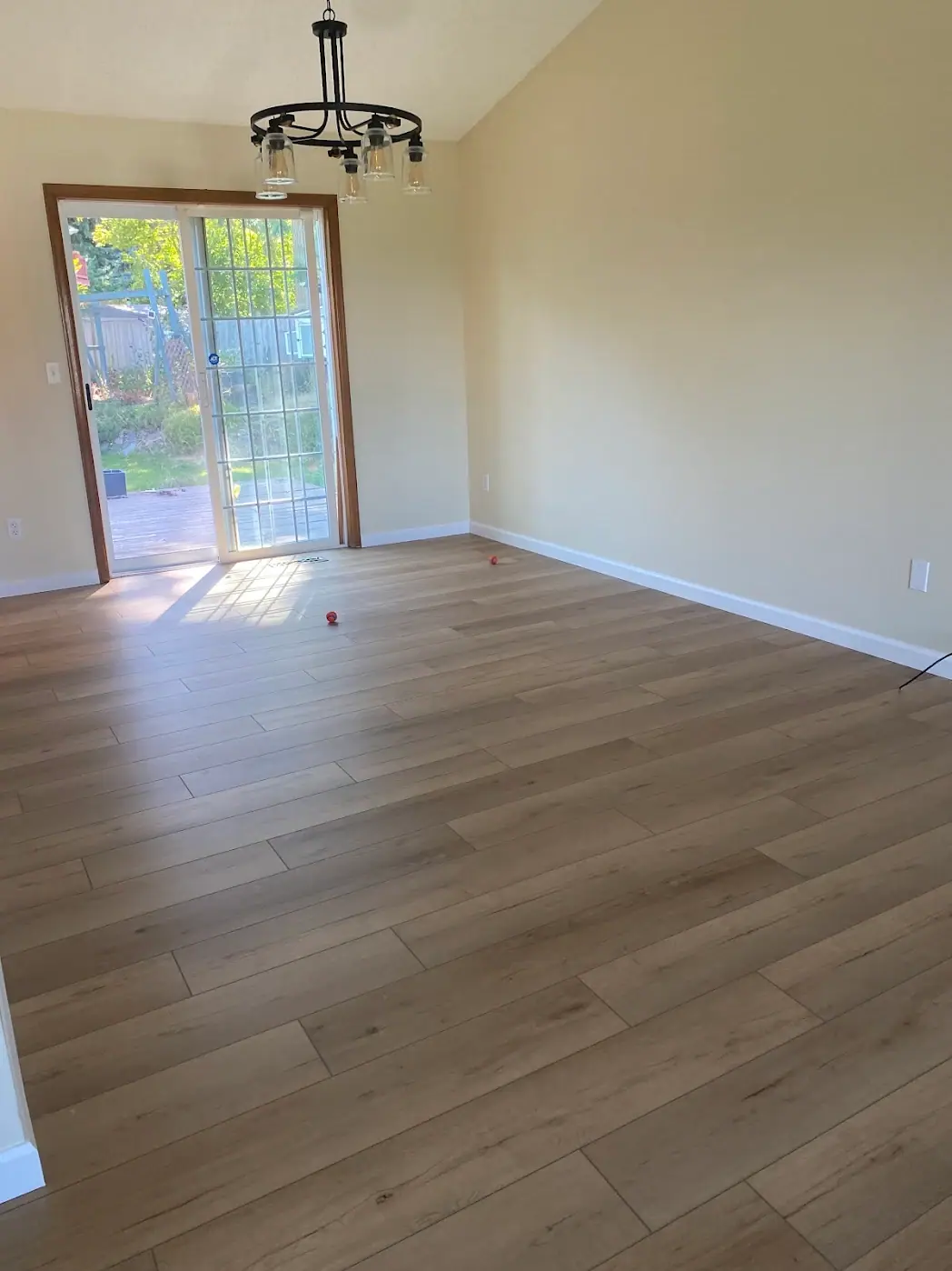 Dining area with wood-look plank flooring, painted walls and a sliding glass door